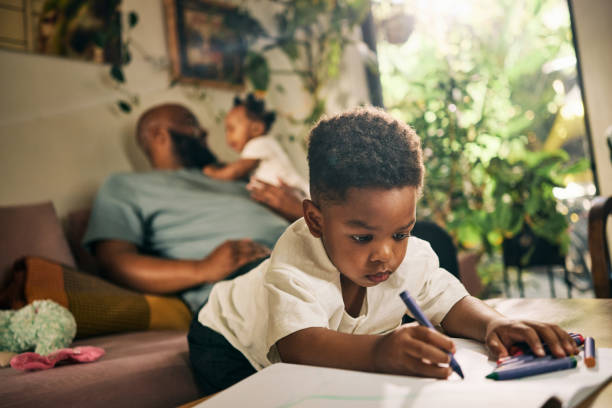 istock A Relaxed Dad Multitasks with Baby and Child, Fostering Creativity and Bonding in Their Warm, Inviting Living Space 1806296749