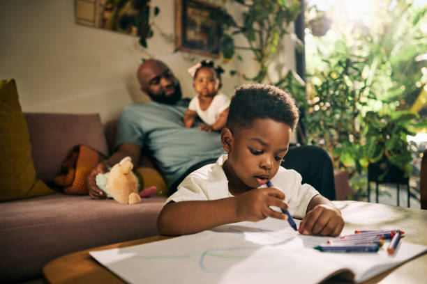 istock A Relaxed Dad Multitasks with Baby and Child, Fostering Creativity and Bonding in Their Warm, Inviting Living Space 1806297015