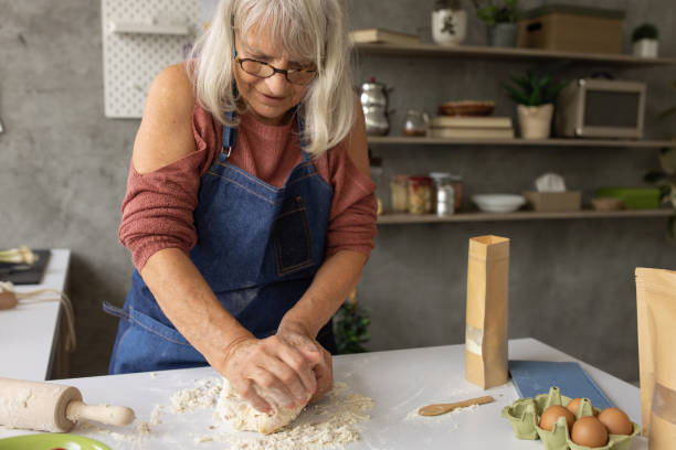 istock Old woman kneading dough 1806301821