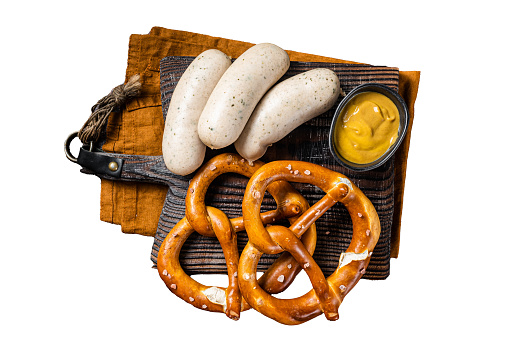 Traditional German pretzel with white sausage and mustard.  Isolated, white background