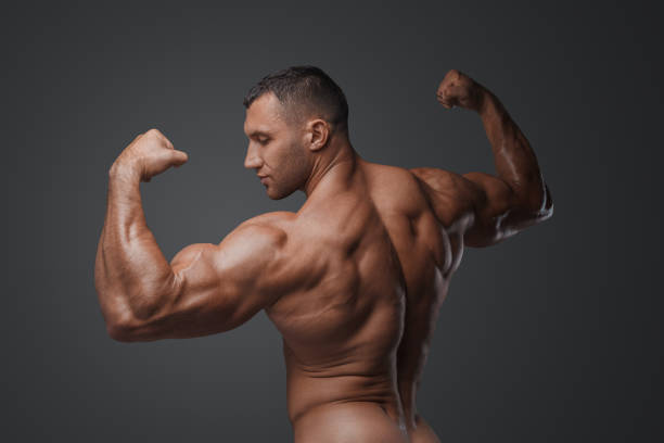 Muscular Man with Tense Muscles on Gray Background