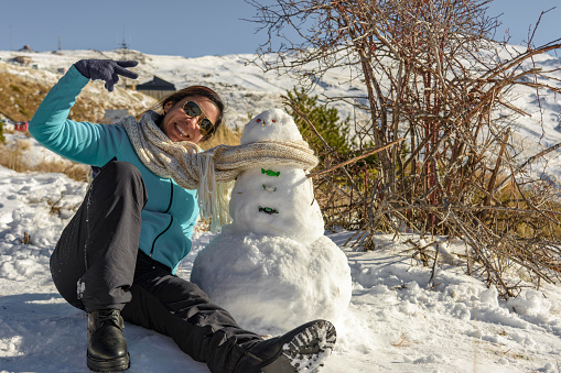 Snowy Escapades Happy Latina Woman Making Memories with Snowman,