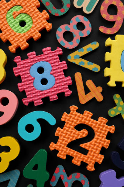 istock Many colorful numbers and mathematical symbols on black background, flat lay 1806305201