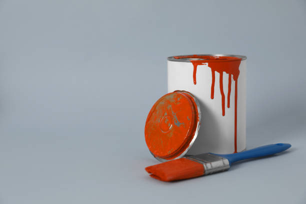 istock Can of orange paint and brush on grey background. Space for text 1806326904