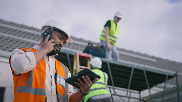 Construction, man and phone call with tablet on site for communication, update and progress of solar panel installation. Male foreman, safety vest and helmet with technology for online, stats or data