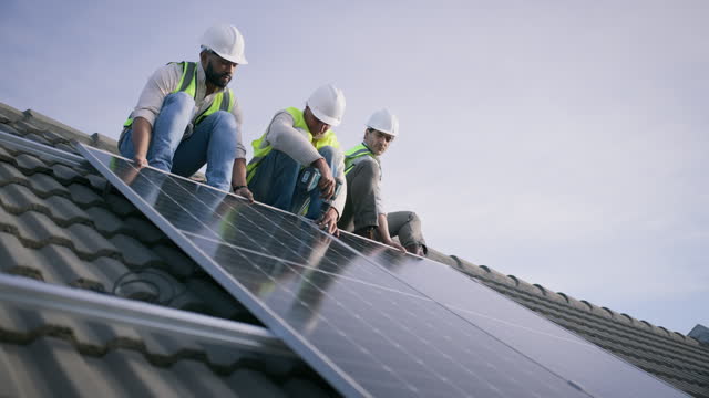 House, rooftop solar panel installation and people teamwork on photovoltaic plate, eco sustainability or renewable energy. Power drill, labour service tools and engineer work on electricity cell