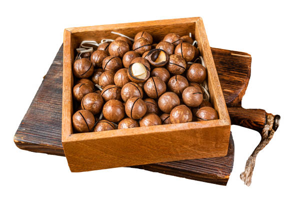 istock Macadamia natural nuts in a box. Isolated, white background. 1806345056