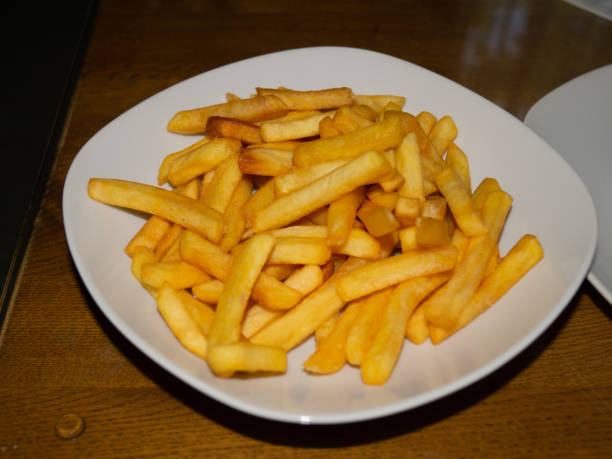 istock Yellow fries in a white plate ready to eat 1806347335