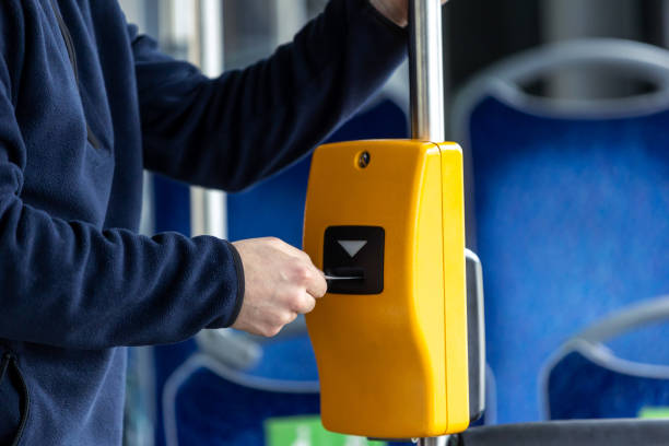 istock Young man hand inserts the bus ticket into the validator, validating and ticking 1806359141