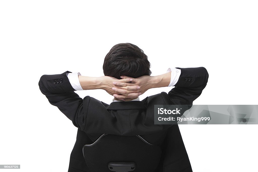 Rear viwe of a relaxed businessman Rear viwe of a relaxed businessman with hands behind his head Adult Stock Photo