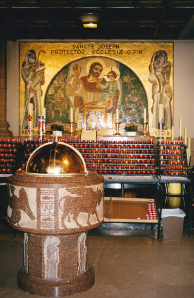 Baptistery of Notre-Dame Cathedral, Luxembourg City, Luxembourg Luxembourg City, Luxembourg: baptistery at Notre-Dame Cathedral - baptismal font, candles, and altar with mosaic with Saint Joseph and Jesus - Roman Catholic Cathedral of Luxembourg City, It was originally a Jesuit church, completed in 1613. notre dame cathedral of luxembourg stock pictures, royalty-free photos & images