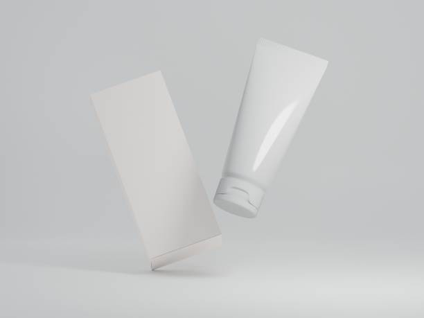 無地の白い背景に包装箱が浮かぶ光沢のある化粧品のモックアップ - dental hygiene branding packaging toothpaste ストックフォトと画像