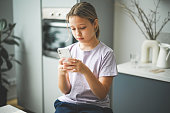 schoolgirl doing homework ( smartphone)