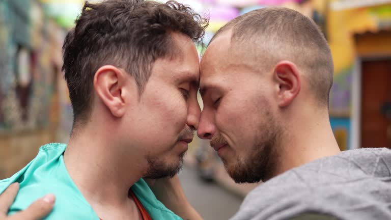 Gay couple face to face outdoors