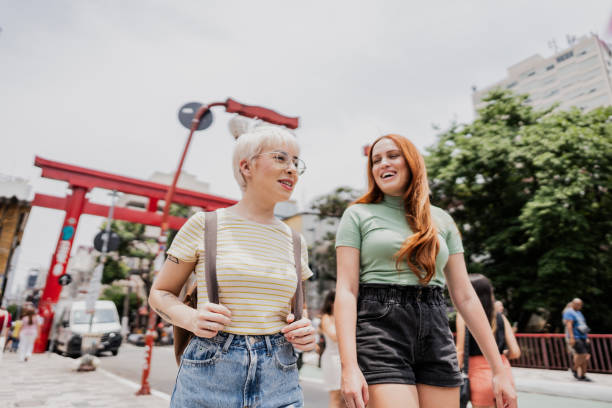 istock Young friends talking and walking through oriental district 1806387148