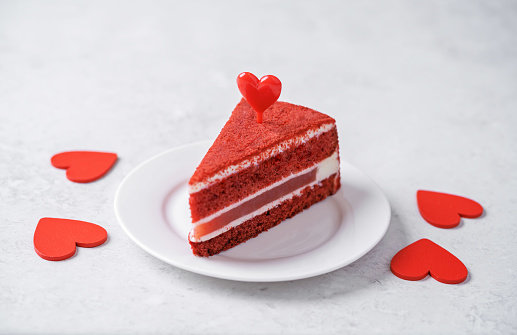 Red heart shaped cake on the table, Catering for Cake, man and woman, Cake with heart shaped love lettering on plate, Mousse Heart shaped cake with heart shaped love inscription for Valentine's Day and 14 February and small cake on cafe background, Tea and coffee, macaroon and cookies