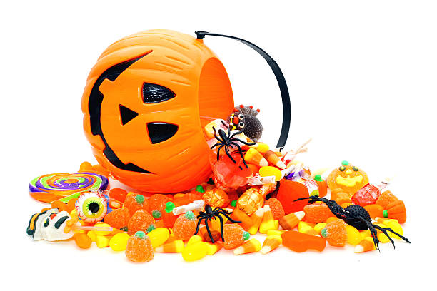 istock Halloween candy spilling from Jack o Lantern pail 180639473