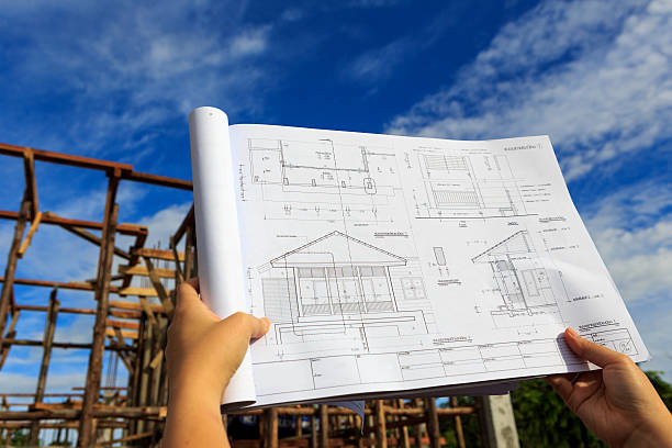 istock architecture drawings in hand on house building background 180641526
