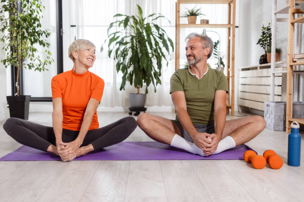 istock A cheerful man and a woman doing their routine home workout 1806417833