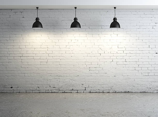 istock A white brick wall with black ceiling lamps 180641922