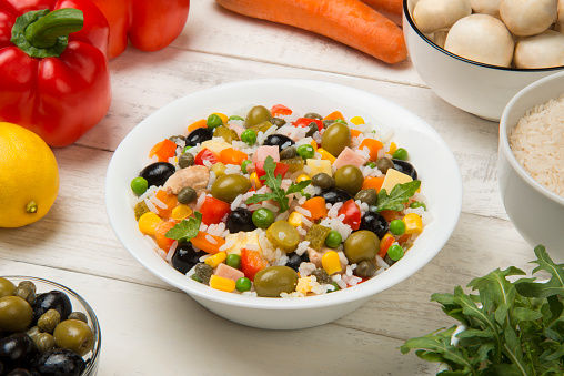 Traditional Italian rice salad in a white porcelain salad bowl.
