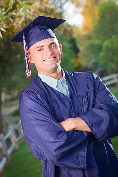 Photo of Handsome Male Graduate in Cap and Gown
