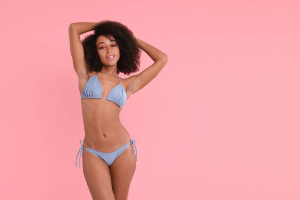 istock Beautiful woman in stylish bikini on pink background, space for text 1806453502