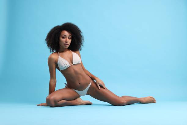 istock Beautiful woman in stylish bikini posing on light blue background 1806455427
