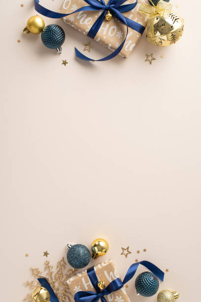 istock New Year Elegance: Top view vertical image featuring craft gift boxes, stylish baubles, snowflake ornament, and sparkling confetti on a pastel beige background. Perfect for New Year messages or ads 1806465808