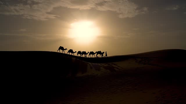 Silhouette of two Berber men leading a camel caravan