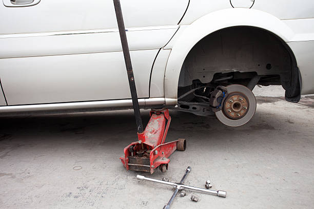 istock changing a wheel of  modern car 180649665