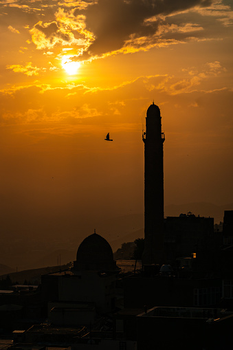 Silhouette view of the Grand Mosque in the ancient city of Mardin at sunset. Dove and minaret, symbols of Mardin. Taken at sunset with a full frame camera.