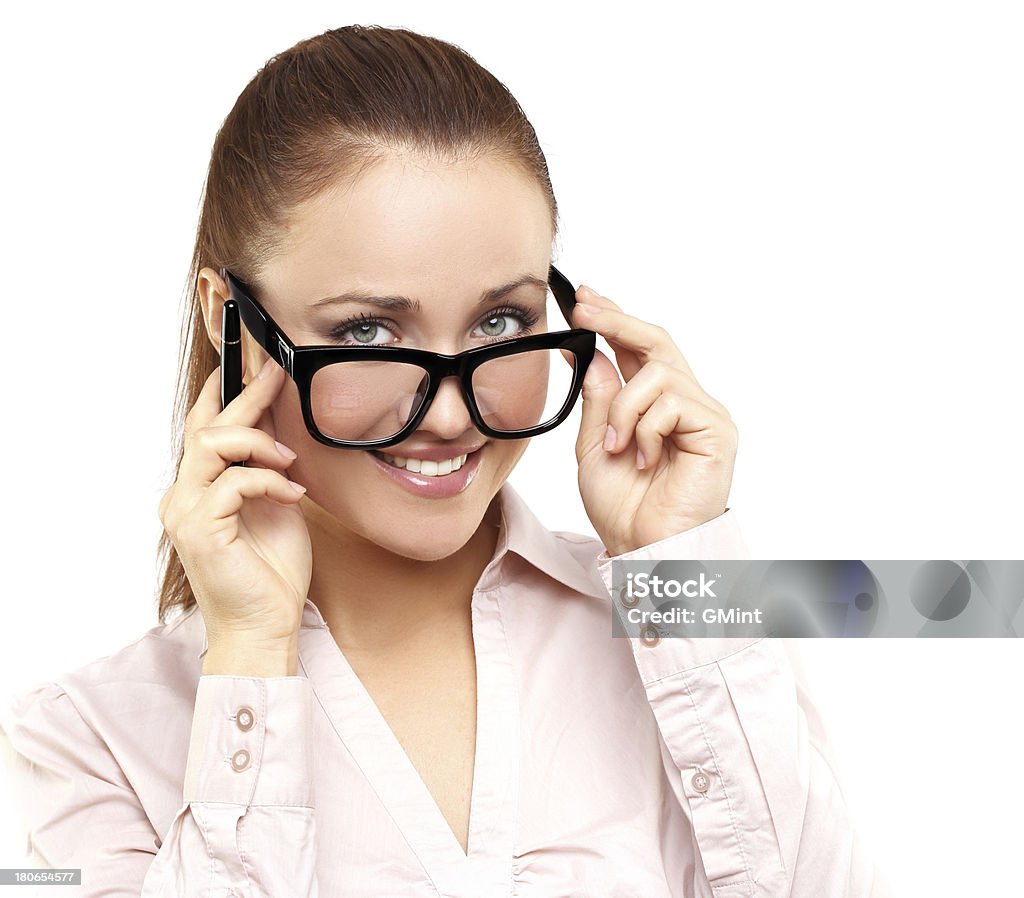 Joven mujer agarrando su gafas y sonriendo a la cámara. - Foto de stock de 20-24 años libre de derechos