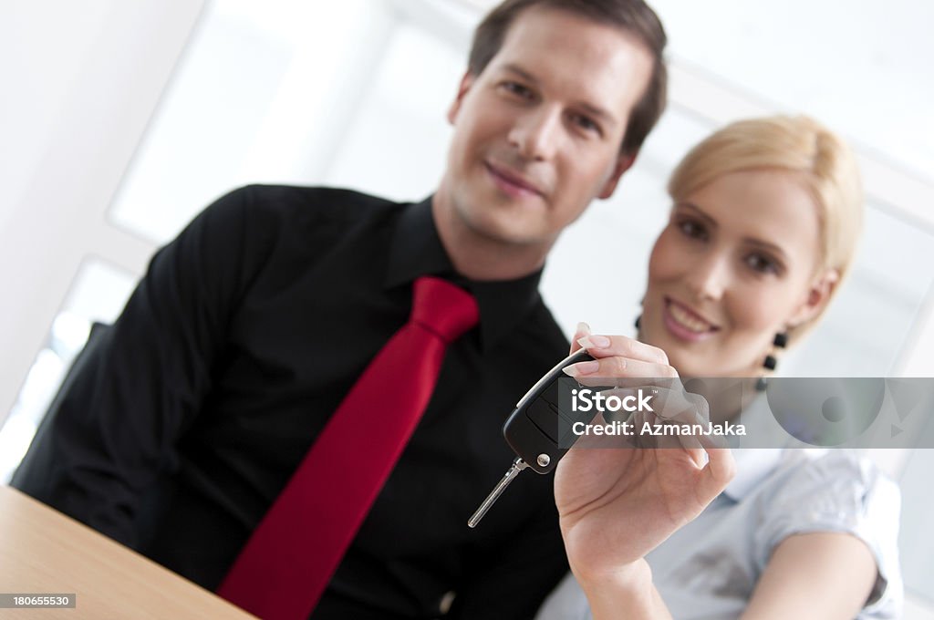 Finally new car Young couple holding keys to their new car Adult Stock Photo