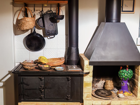 View of a firewood iron stove, a fireplace and some kitchen utensils in a farm house near the colonial town of Villa de Leyva, in central Colombia.