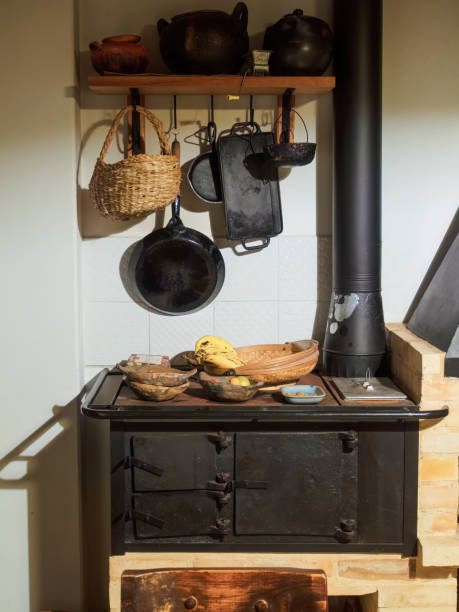istock View of a firewood iron stove and some kitchen utensils 1806565615