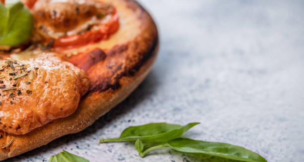 istock Pizza with cheese and tomatoes with basil leaves close-up. 1806566147