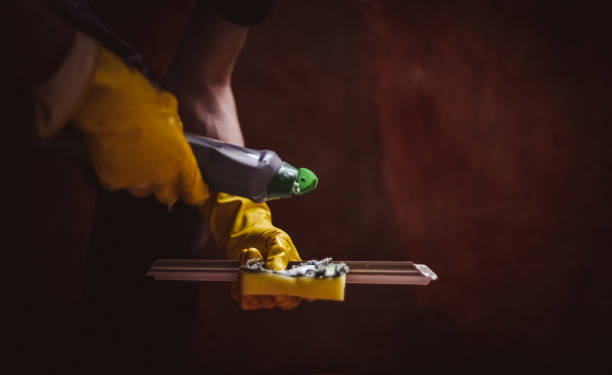 istock A young man washes window frames with water and a sponge. 1806569808