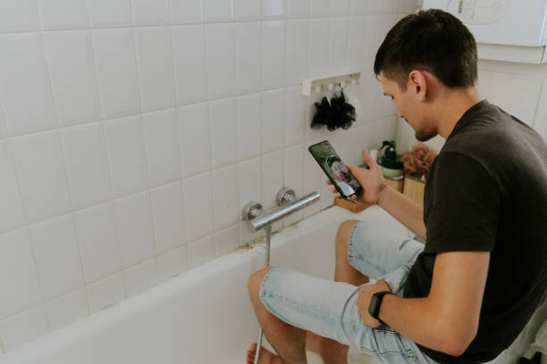istock A young man installs a faucet in the bathroom. 1806569820