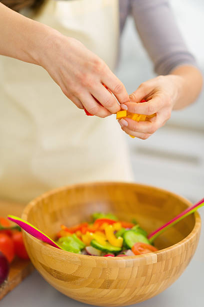 istock Closeup on housewife preparing vegetable salad 180657213