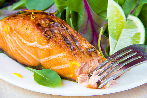 Grilled fillet of red salmon and salad with lettuce stock photo