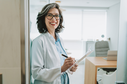 Portrait of a female doctor holding a clipboard