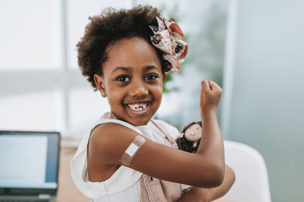 Child with bandage on arm after vaccine