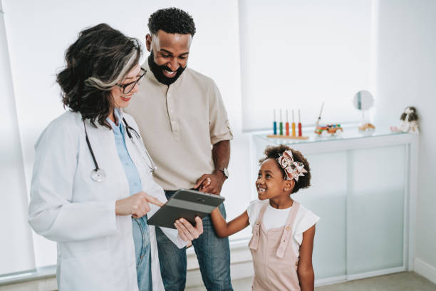 istock Father takes daughter to doctor's appointment 1806608543