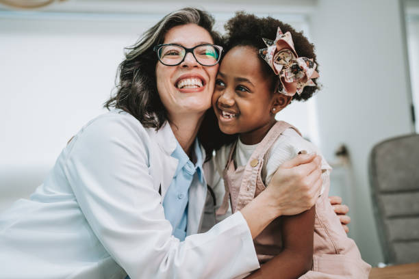 istock Doctor hugs child patient 1806608546