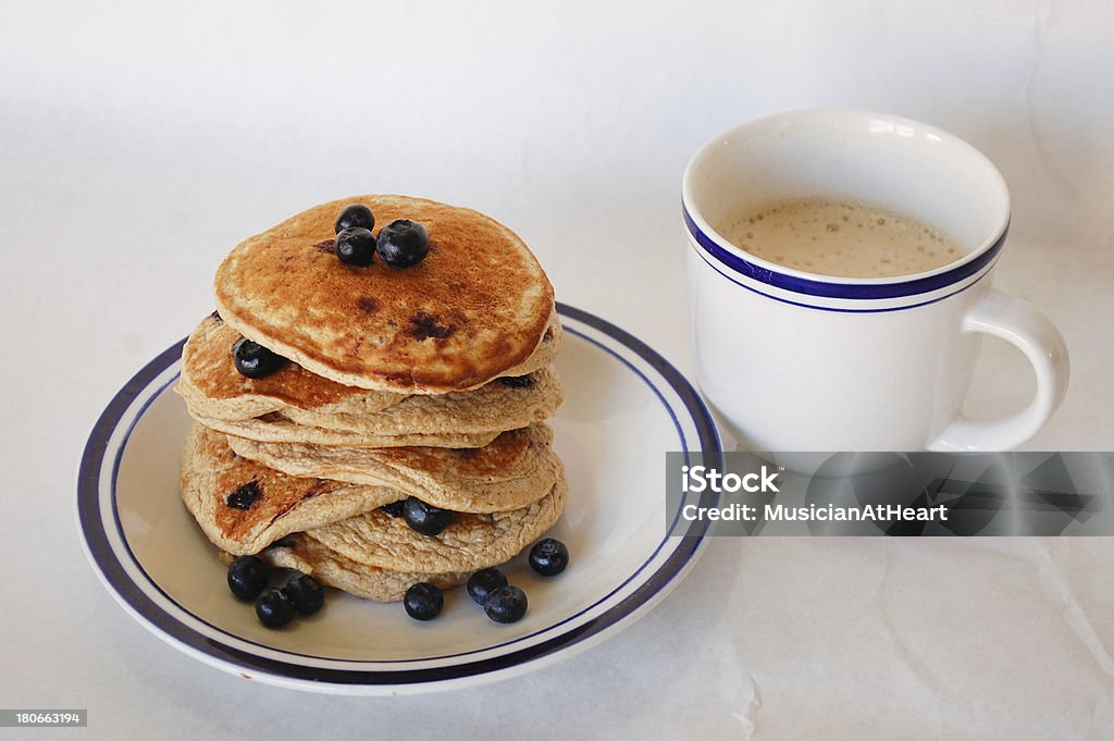 Blueberry Oat Pancakes and Coffee Stack of blueberry oat pancakes on a plate and a cup of coffee with a white background. Antioxidant Stock Photo