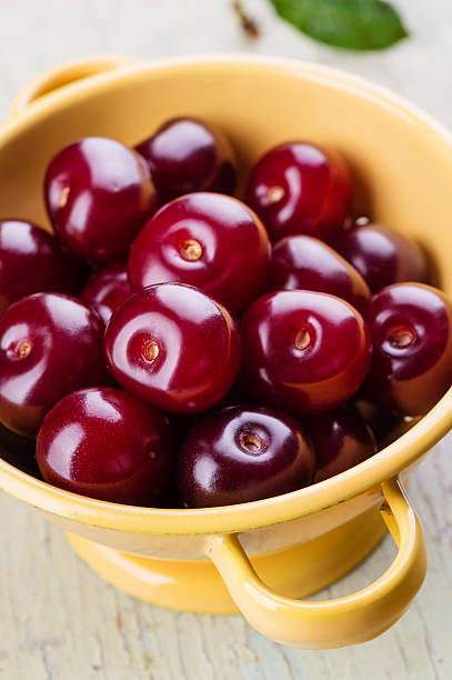 Ripe cherry in colander stock photo
