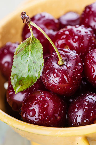 Cherry with a leaf and water drops stock photo