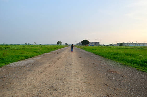 Photographer at Construction Site Located in Rural India Landscape.
