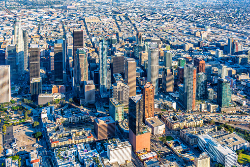 The downtown and surrounding neighborhoods of the city of Los Angeles, California shot via helicopter from an altitude of about 1100 feet.